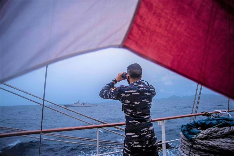 An Indonesian Naval cadets uses binoculars as he monitors the signal from the KRI Diponegoro-365 during a joint excercise on guarding Indonesia's borders, in the North Natuna sea, Riau islands, Indonesia, 1 October 2021. (Antara Foto/Muhammad Adimaja/via Reuters)