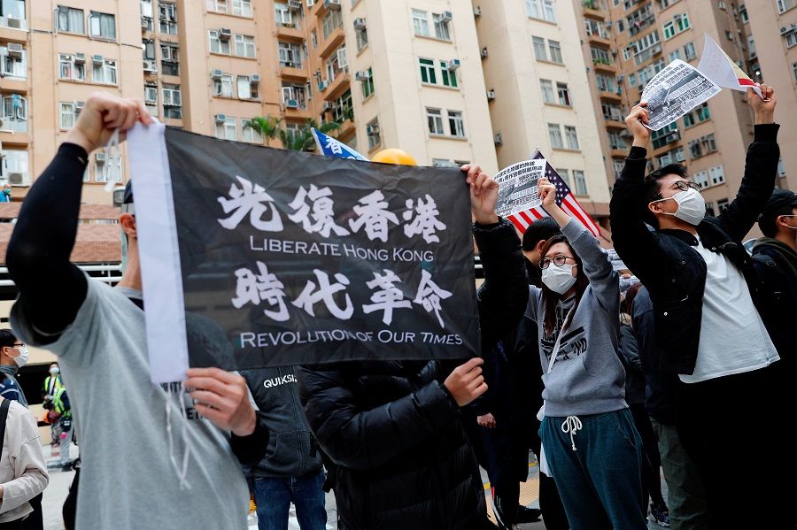 Residents wear face masks as they march to protest against the government's plan to set up a quarantine site close to their community amid the Covid-19 coronavirus outbreak, in Hong Kong, on 2 February 2020. (Tyrone Siu/Reuters)