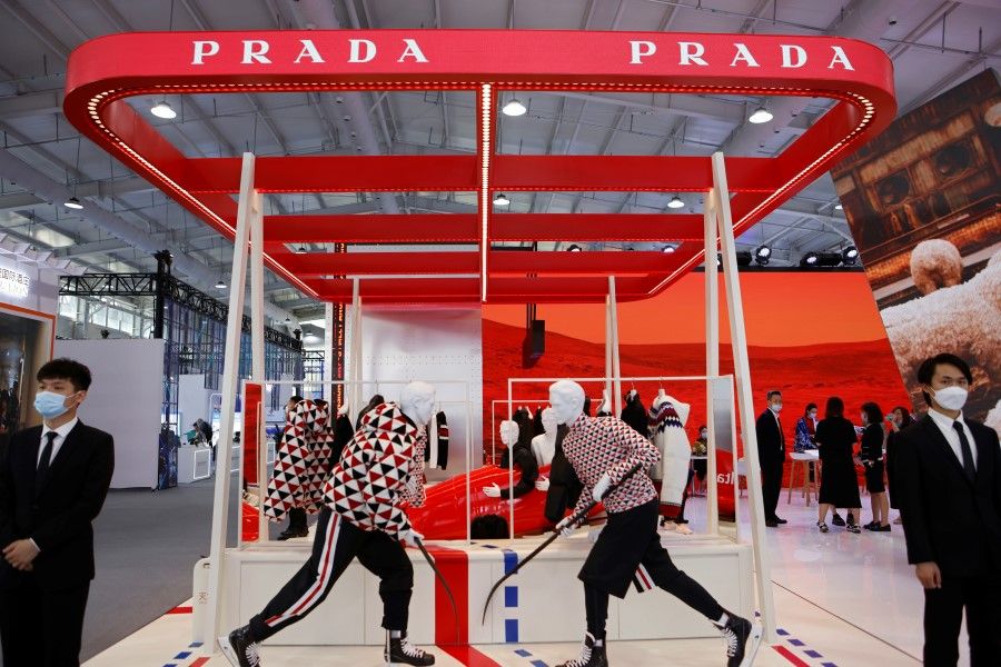 Staff members stand next to the "Prada On Ice" collection, launched by Prada ahead of the upcoming 2022 Beijing Winter Olympics, at the 2021 China International Fair for Trade in Services (CIFTIS) in Beijing, China, 3 September 2021. (Florence Lo/Reuters)