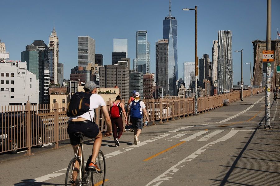 People ride their bikes across the Brooklyn Bridge as Manhattan enters Phase 2 of re-opening following restrictions imposed to curb the Covid-19 pandemic on 22 June 2020 in New York City. (Spencer Platt/Getty Images/AFP)