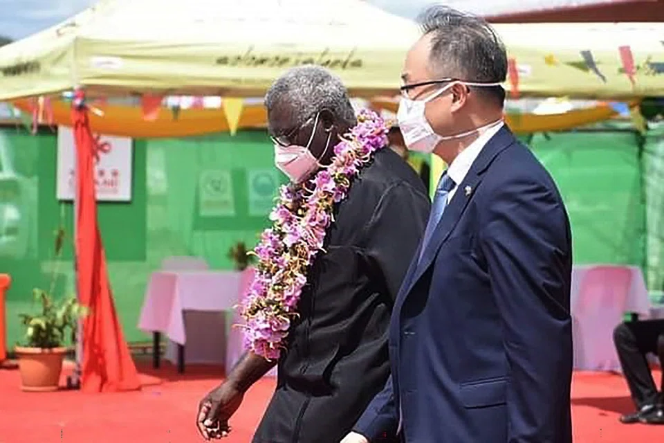 A photo taken on 22 April 2022 shows China's ambassador to the Solomon Islands Li Ming (right), and Solomons Prime Pinister Manasseh Sogavare (left) attending the opening ceremony of a China-funded national stadium complex in Honiara, Solomon Islands. (Mavis Podokolo/AFP)