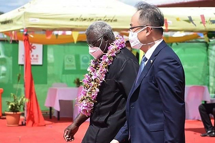 A photo taken on 22 April 2022 shows China's ambassador to the Solomon Islands Li Ming (right), and Solomons Prime Pinister Manasseh Sogavare (left) attending the opening ceremony of a China-funded national stadium complex in Honiara, Solomon Islands. (Mavis Podokolo/AFP)