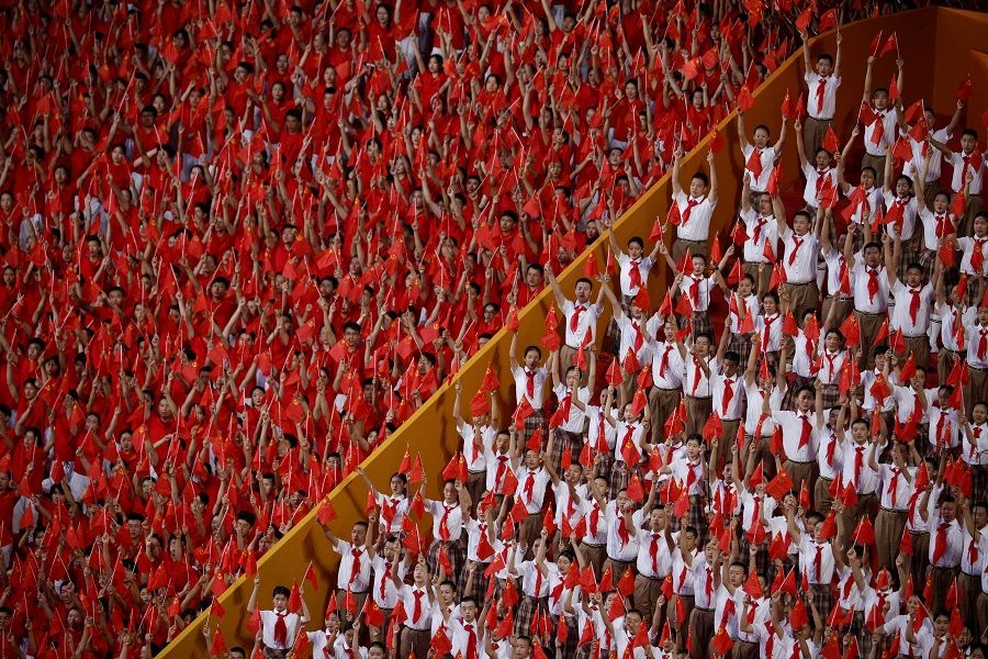Spectators attend a performance commemorating the 100th anniversary of the founding of the Communist Party of China at the National Stadium in Beijing, China, 28 June 2021. (Thomas Peter/Reuters)