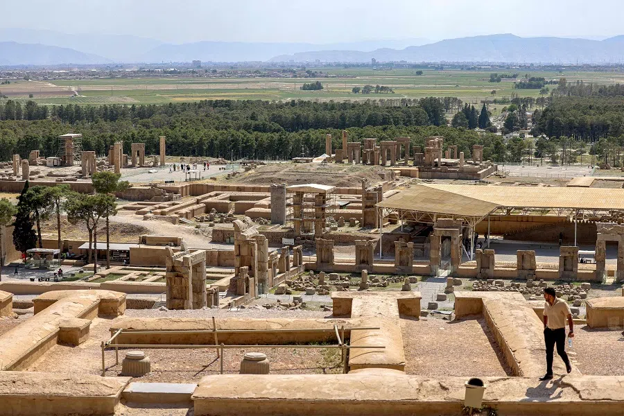 A man walks in the ruins of ancient Persepolis, which served as the capital of the Achaemenid Persian Empire (550-330 BC), in southern Iran on 13 May 2024. (Atta Kenare/AFP)