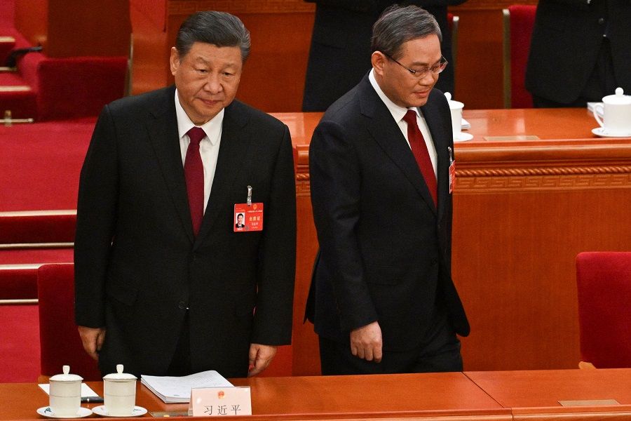 Chinese President Xi Jinping (left) and Premier Li Qiang arrive for the opening session of the National People's Congress (NPC) at the Great Hall of the People in Beijing on 5 March 2024. (Pedro Pardo/AFP)