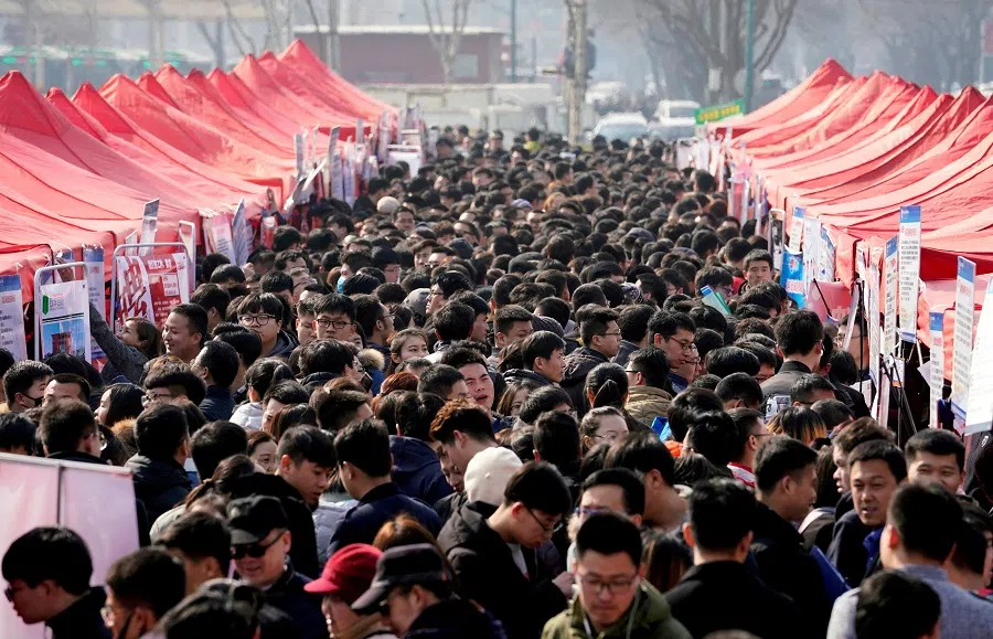 Job seekers crowd a job fair at Liberation Square in Shijiazhuang, Hebei province, China, 25 February 2018.