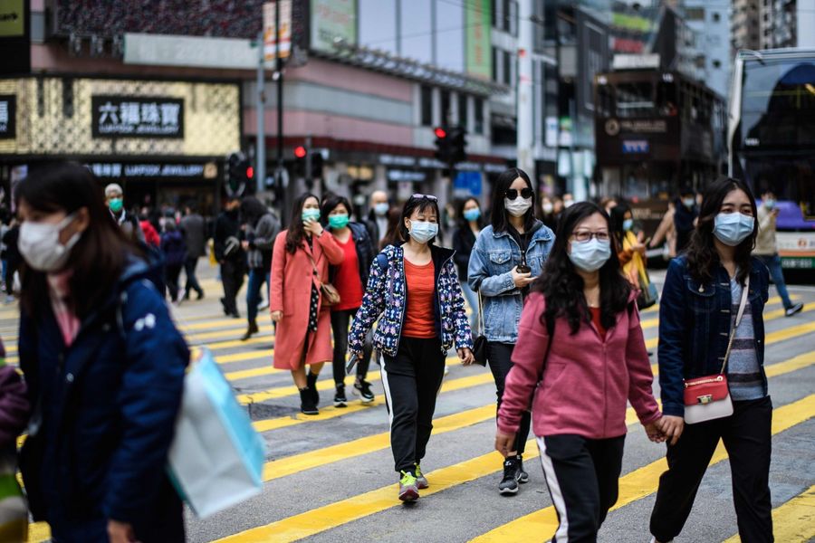 The scale of the Wuhan coronavirus outbreak triggered frightening memories of the 2003 SARS epidemic. In this photo taken in Hong Kong on 27 January 2020, pedestrians are seen wearing face masks while crossing the road as a preventative measure following the Wuhan coronavirus outbreak. (Anthony Wallace/AFP)