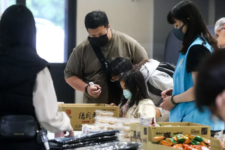 Local residents evacuated following an earthquake get food at a temporary centre at an elementary school, in Hualien, Taiwan, on 6 April 2024. (I-Hwa Cheng/AFP)