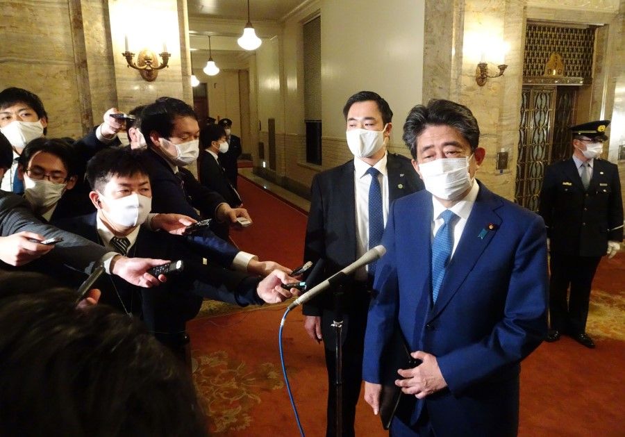 Former Japanese Prime Minister Shinzo Abe speaks to the media after a parliament session in Tokyo on 25 December 2020. (STR/AFP)