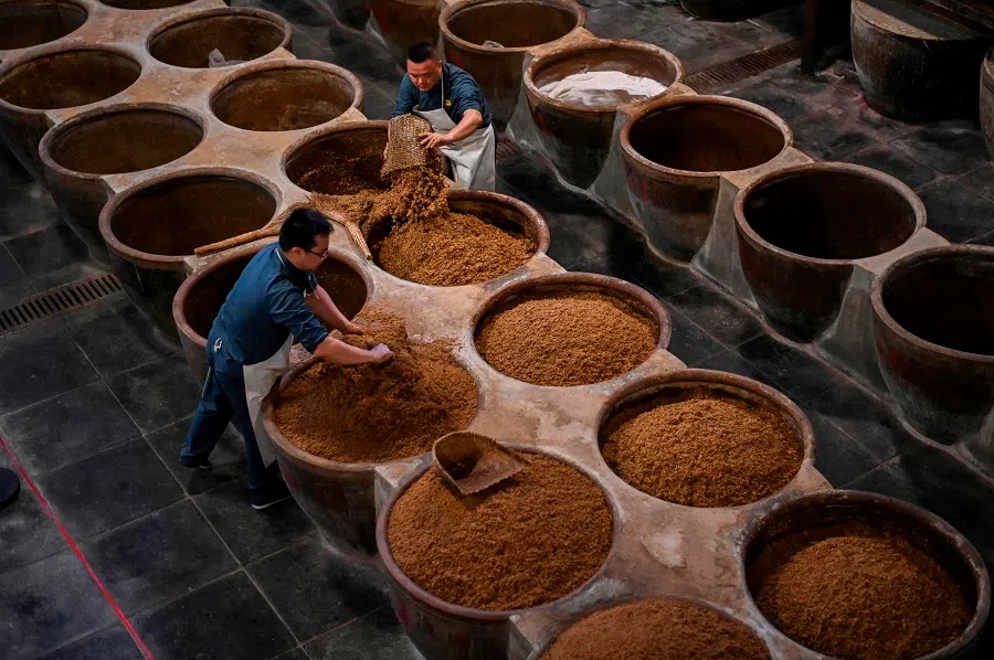 In this photograph taken on 12 October 2020, workers produce rice vinegar at the Jiangsu Hengshun Group production plant in Zhenjiang, Jiangsu, China. (Hector Retamal/AFP)