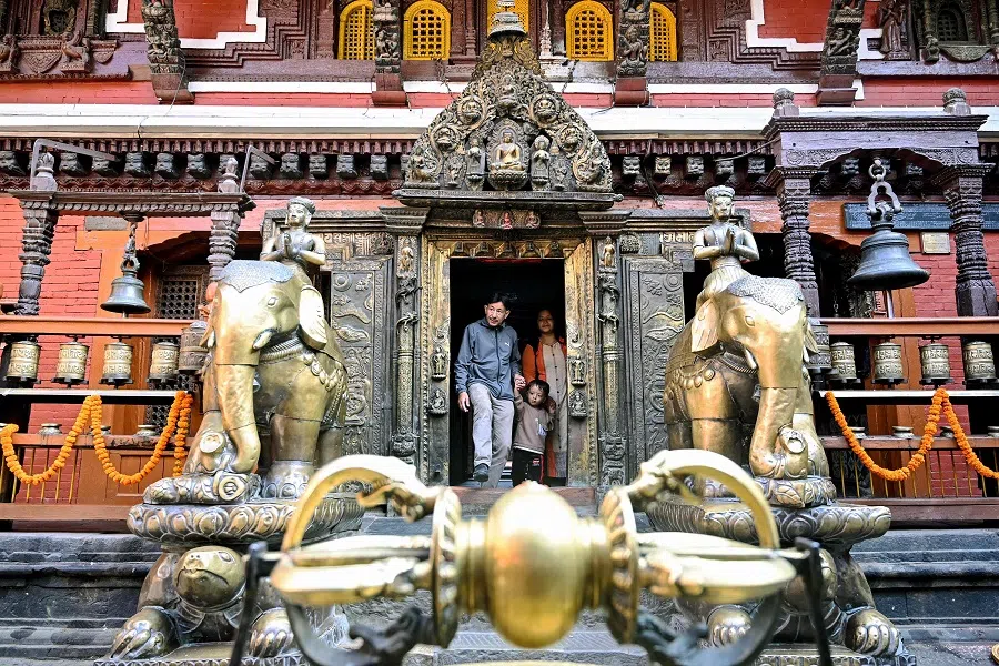 Devotees arrive to offer prayers at a temple near Patan Durbar Square in Lalitpur on 18 November 2024. (Prakash Mathema/AFP)