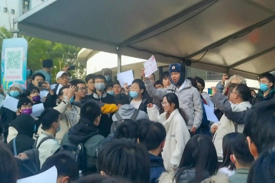 This frame grab from video footage made available via AFPTV on 27 November 2022 shows students protesting against China's zero-Covid policy at Tsinghua University in Beijing, China. (AFPTV/AFP)