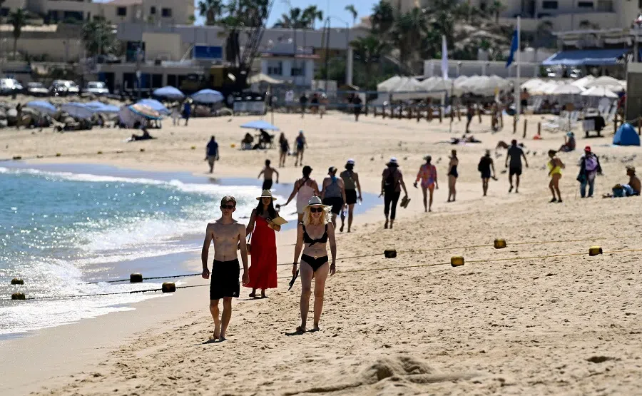 Tourists enjoy the beach at a resort in Los Cabos, Baja California State, Mexico, on 24 February 2024. (Alfredo Estrella/AFP)
