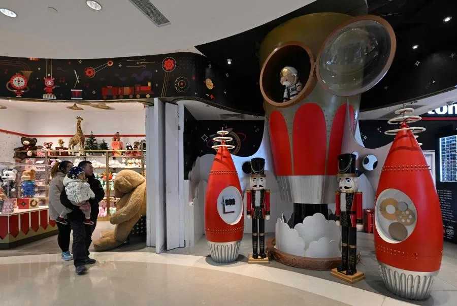 People visit a shopping mall in Beijing on 14 January 2026. (Adek Berry/AFP)