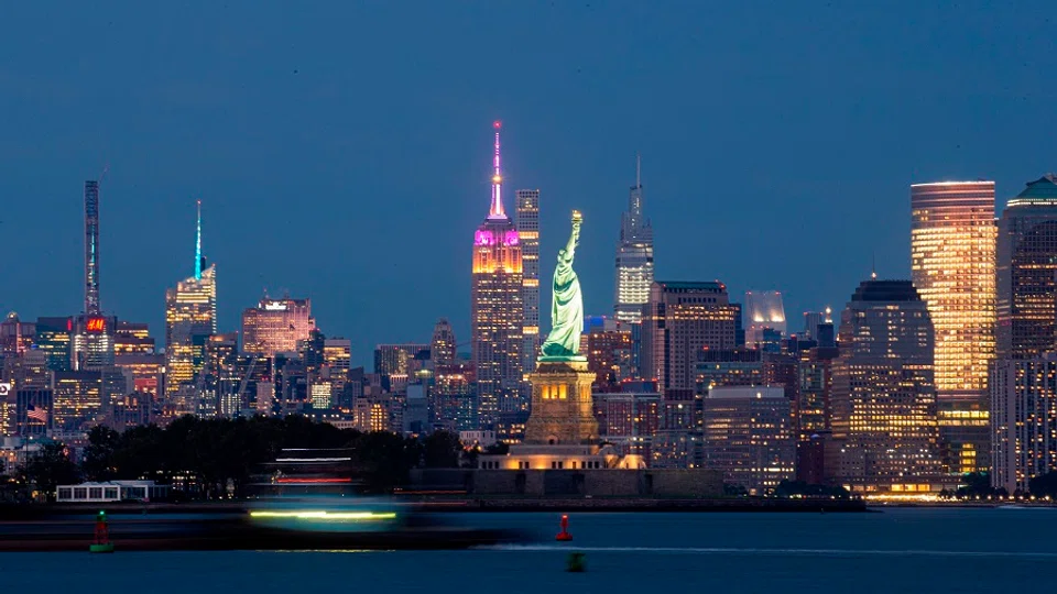 The Empire State Building and the World Trade Center sit behind the Statue of Liberty in New York City, 26 August 2020. (Kena Betancur/AFP)