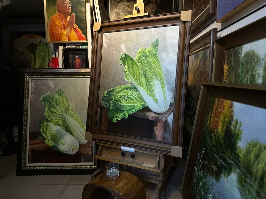 Ouyang Feng’s one-metre-tall realist painting of a cabbage is displayed prominently in his studio.