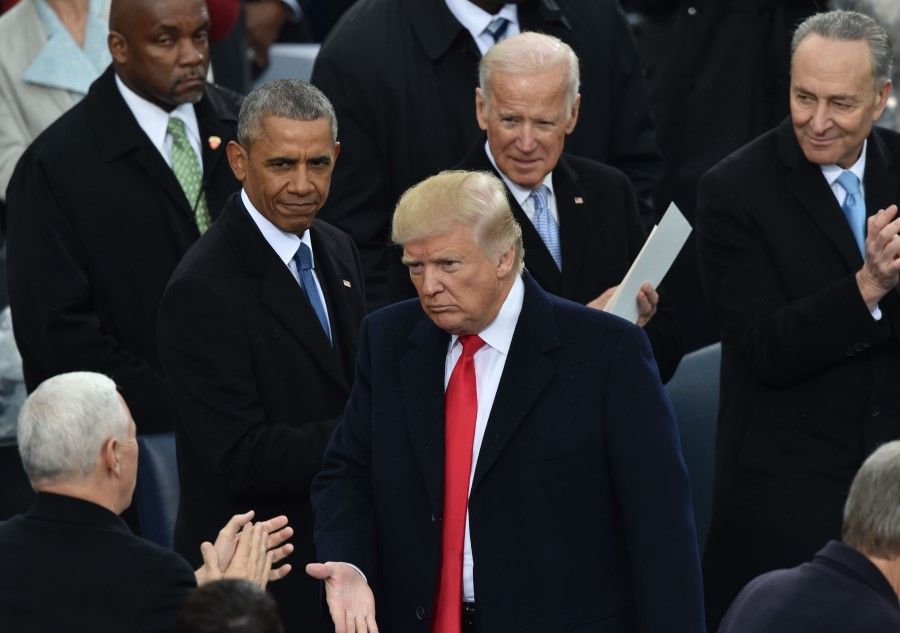 In this file photo US President Donald Trump (C) is applauded by former President Barack Obama (L) and former Vice President Joe Biden during Trump's inauguration ceremonies at the US Capitol in Washington, DC, on 20 January 2017. (Paul J. Richards/AFP)