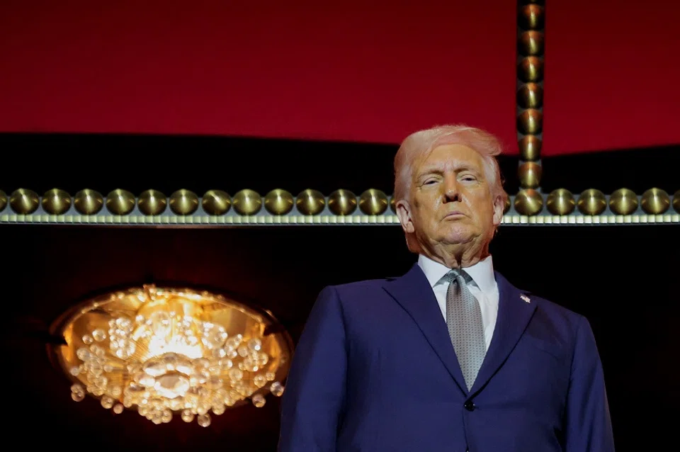 US President Donald Trump gestures stands at the presidential box at the Kennedy Center, in Washington, DC, US, on 17 March 2025. (Carlos Barria/Reuters)