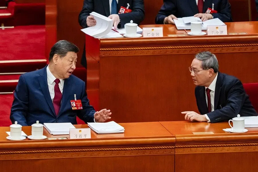 Chinese President Xi Jinping, left, speaks with Chinese Premier Li Qiang during the opening session of the National People’s Congress at the Great Hall of People in Beijing, China, on 5 March 2026. (Qilai Shen/Bloomberg)