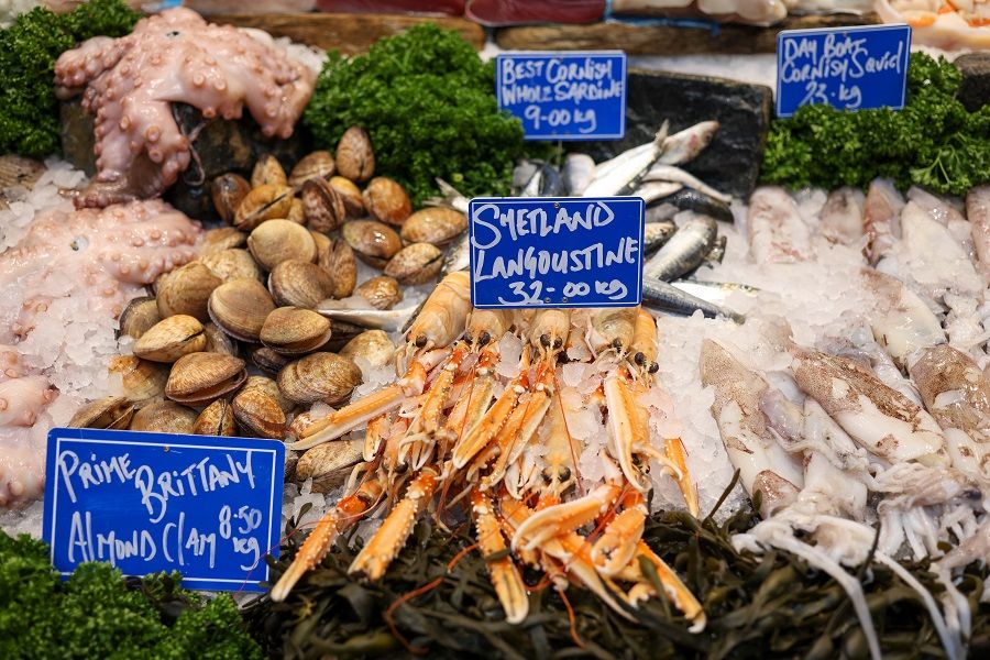 Almond clams and shetland langoustine for sale at a fishmongers stall at Borough Market in London, UK, 15 December 2021. (Hollie Adams/Bloomberg)