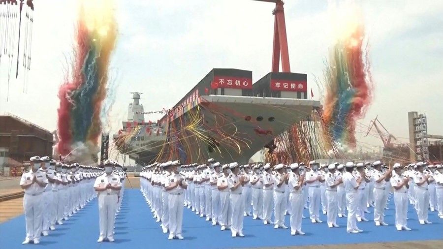 This screen grab made from video released by Chinese state broadcaster CCTV shows the launch ceremony of the Fujian, a People's Liberation Army (PLA) aircraft carrier, at a shipyard in Shanghai on 17 June 2022. (CCTV/AFP)