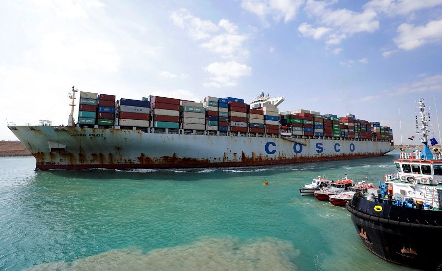 A shipping container of the China Ocean Shipping Company (COSCO) moves through the Suez Canal in Suez, Egypt, 15 February 2022. (Mohamed Abd El Ghany/Reuters)