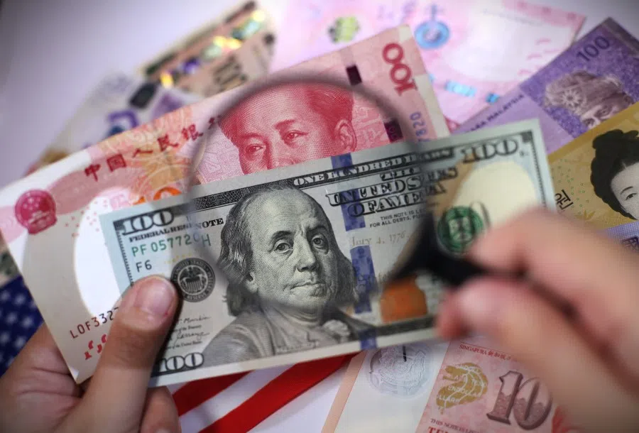 An illustration photo showing a US dollar note and an RMB note.