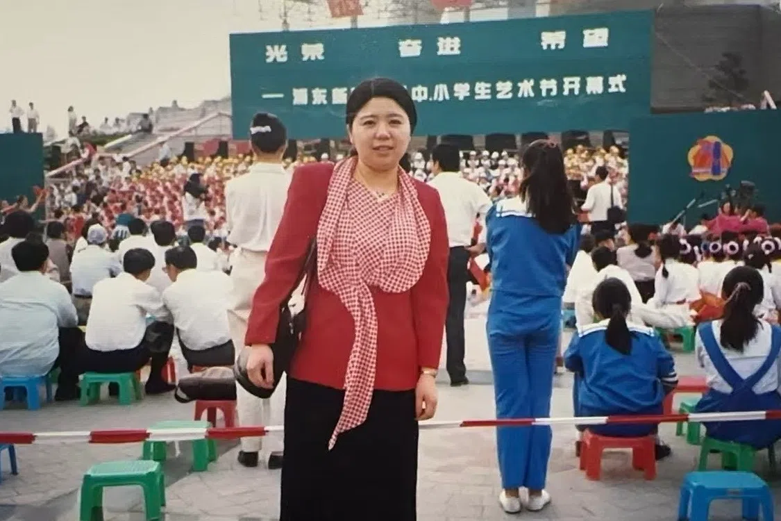 A photo of the author’s mother in front of the Oriental Pearl Tower. (Photo provided by the author’s parents)