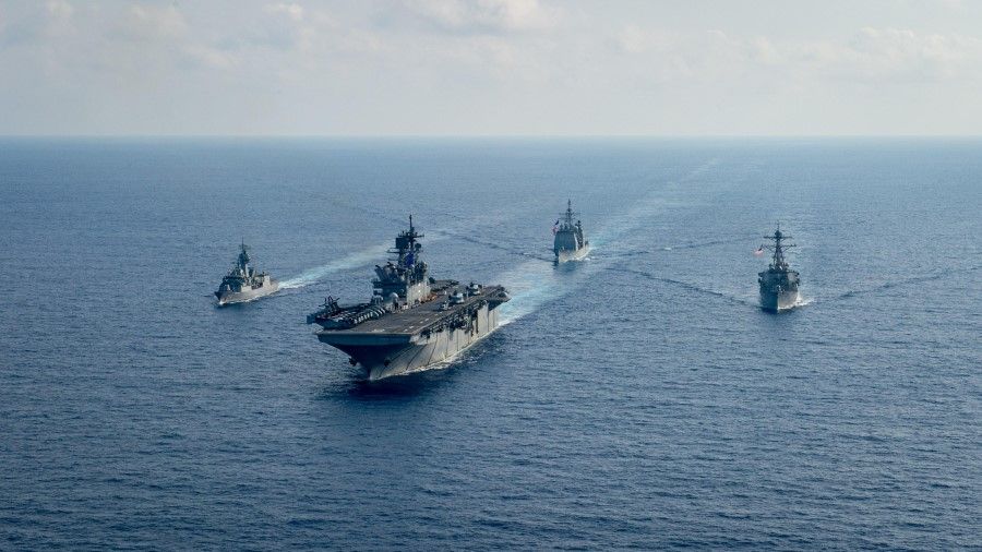 Royal Australian Navy guided-missile frigate HMAS Parramatta (FFH 154) (left) sails with U.S. Navy Amphibious assault ship USS America (LHA 6), Ticonderoga-class guided-missile cruiser USS Bunker Hill (CG 52) and Arleigh-Burke class guided missile destroyer USS Barry (DDG 52) in the South China Sea, 18 April 2020. (Petty Officer 3rd Class Nicholas Huynh/US Navy/Handout via Reuters)