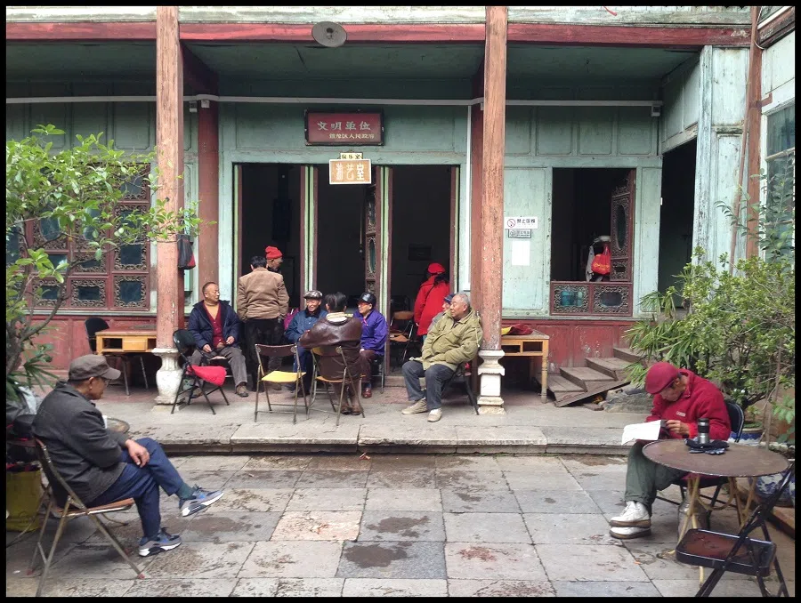 Seen here are some elderly and the retired killing time at a recreation room in rural Yunnan by sharing stories and playing games.