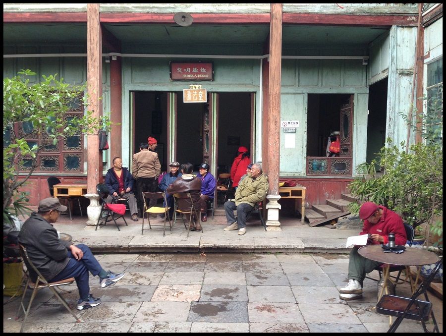 Seen here are some elderly and the retired killing time at a recreation room in rural Yunnan by sharing stories and playing games.