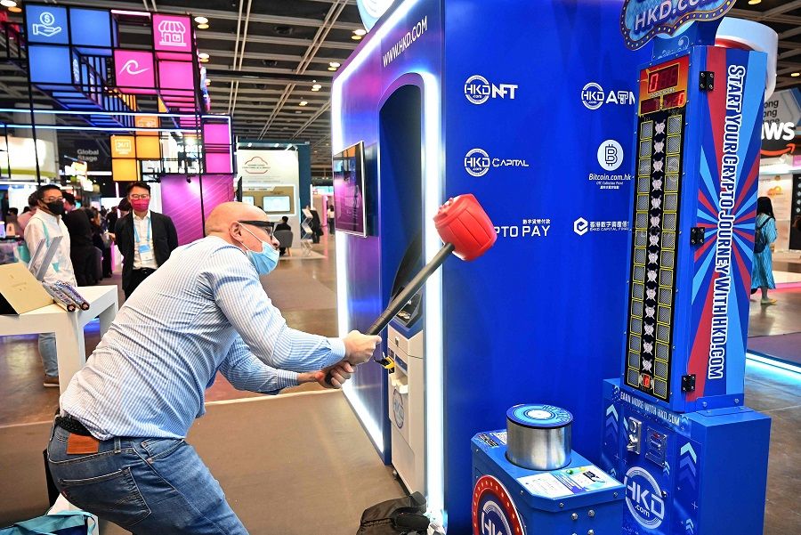A visitor plays a game at a booth of the Hong Kong Digital Asset Exchange on the first day of Fintech Week 2022 in Hong Kong, China, on 31 October 2022. (Peter Parks/AFP)