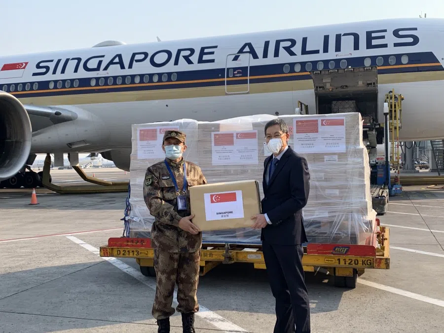 Singapore Ambassador to China Lui Tuck Yew (right) handing over the Republic's humanitarian assistance to People's Liberation Army General Hospital Medical Service Department deputy head Zhang Fu in Beijing on on 19 February 2020. (MFA Singapore)