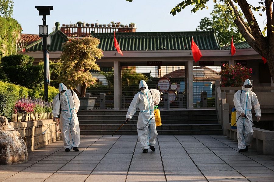 This photo taken on 6 October 2021 shows staff members spraying disinfectant at Gulangyu as the island prepares to reopen to tourists after being closed due to the outbreak of the Covid-19 coronavirus, in Xiamen, Fujian province, China. (STR/AFP)