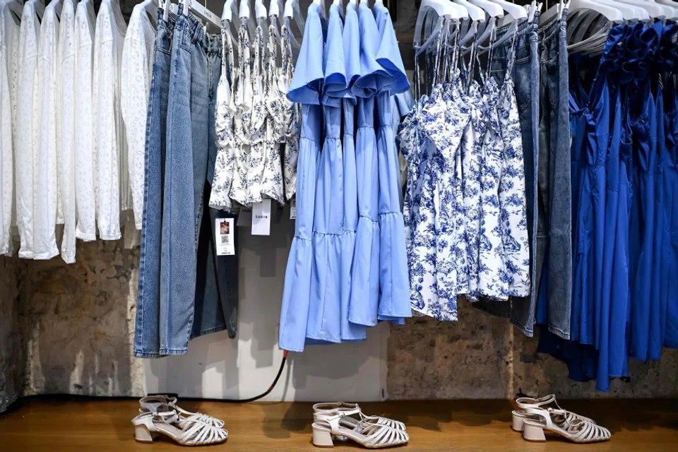 Clothes are displayed on hangers at a Chinese fashion brand Shein pop-up store in Paris on 4 May 2023. (Christophe Archambault/AFP)
