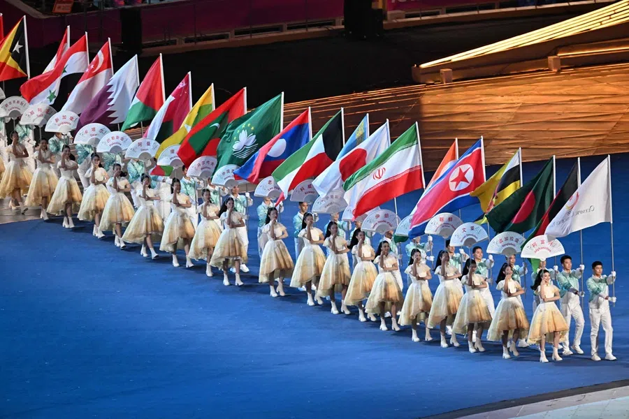 Flags of participating countries are carried during the opening ceremony of the 2022 Asian Games at the Hangzhou Olympic Sports Centre Stadium in Hangzhou in China’s eastern Zhejiang province on 23 September 2023. (Adek Berry/AFP)