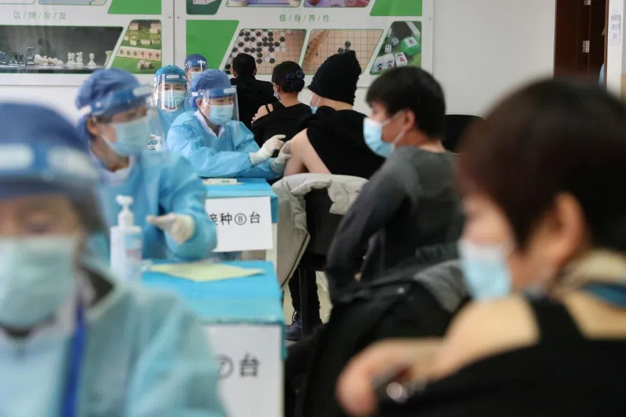 Medical workers in protective suits administer the vaccine against the coronavirus disease (COVID-19) at a makeshift vaccination site in Beijing's Haidian district, China, 8 January 2021. (cnsphoto via Reuters)
