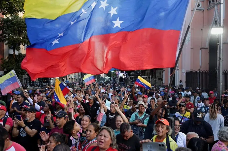Members of the militia group known as “Colectivos” take part in a march calling for the release of Venezuela’s President Nicolas Maduro, after he and his wife Cilia Flores were captured following US strikes on Venezuela, in Caracas, Venezuela, on 4 January 2026. (Gaby Oraa/Reuters)