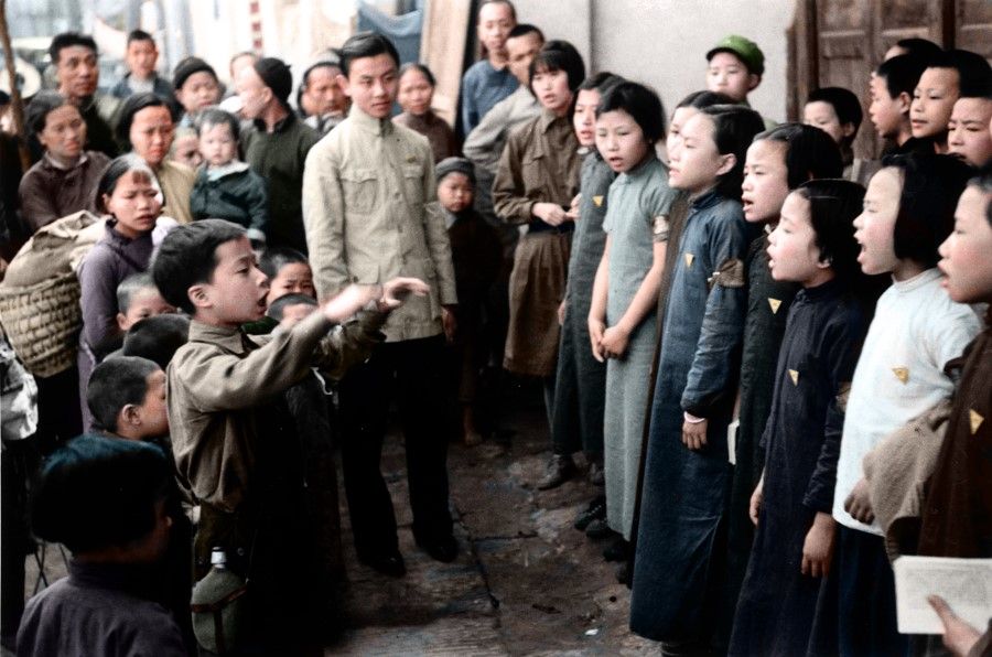 A children's propaganda team sings anti-Japanese songs in the outskirts of Chongqing to inspire the local residents, 1940. While the members of the propaganda team are young, their voices are loud and spirited.