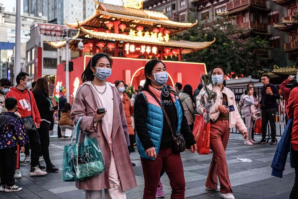 People visit a traditional Spring Festival flower market in Guangzhou, Guangdong province, China, on 20 January 2023. (AFP)