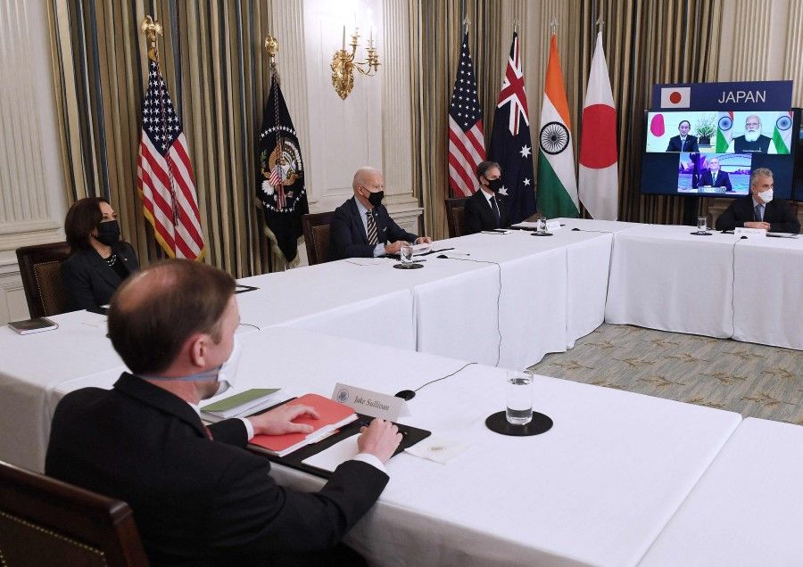 US President Joe Biden (centre), with Secretary of State Antony Blinken (centre right), Vice President Kamala Harris (left) and national security adviser Jake Sullivan meets virtually with leaders of fellow Quad members Australia, India and Japan in the State Dining Room of the White House in Washington, DC on 12 March 2021. (Olivier Douliery/AFP)