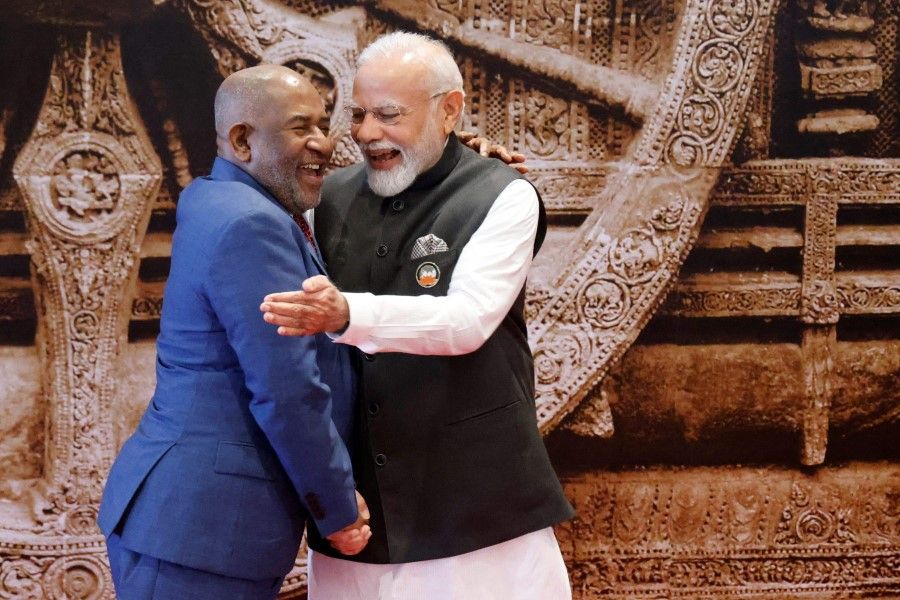 India's Prime Minister Narendra Modi (right) shakes hands with African Union Chairman and Comoros President Azali Assoumani ahead of the G20 Leaders' Summit at Bharat Mandapam in New Delhi on 9 September 2023. (Ludovic Marin/AFP)