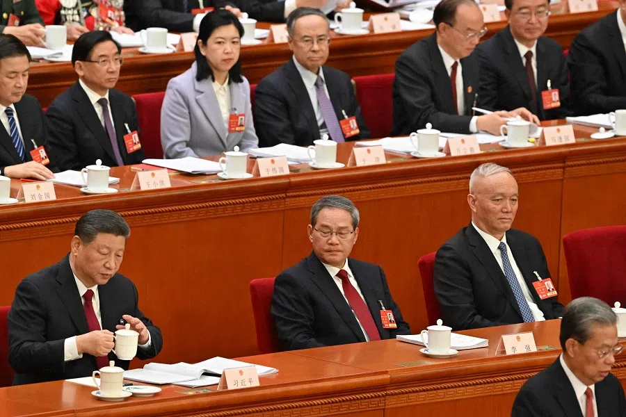 Zhao Leji (right), chairman of the Standing Committee of the National People’s Congress (NPC) and 3rd ranking Chinese official, speaks as China’s President Xi Jinping (left) and Premier Li Qiang (centre) look on during the opening session of the NPC at the Great Hall of the People in Beijing on 5 March 2025. (Adek Berry/AFP)