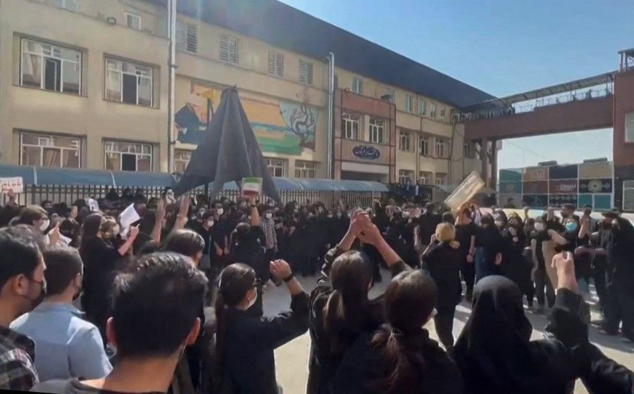 This image grab from a UGC video made available on 15 October 2022, shows Iranian students chanting "Freedom" as they rally at Tehran's University of Science and Culture. (AFP)