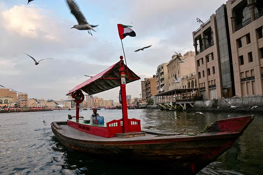 A man rides a traditional wooden boat in Dubai, United Arab Emirates, on 10 March 2025. (Giuseppe Cacace/AFP)