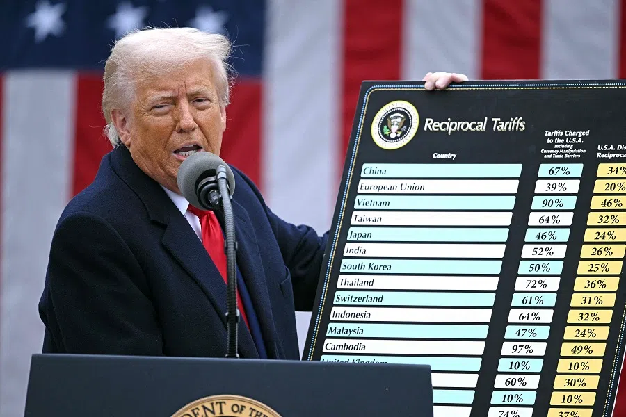 US President Donald Trump holds a chart as he delivers remarks on reciprocal tariffs during an event in the Rose Garden entitled “Make America Wealthy Again” at the White House in Washington, DC, on 2 April 2025. (Brendan Smialowski/AFP)