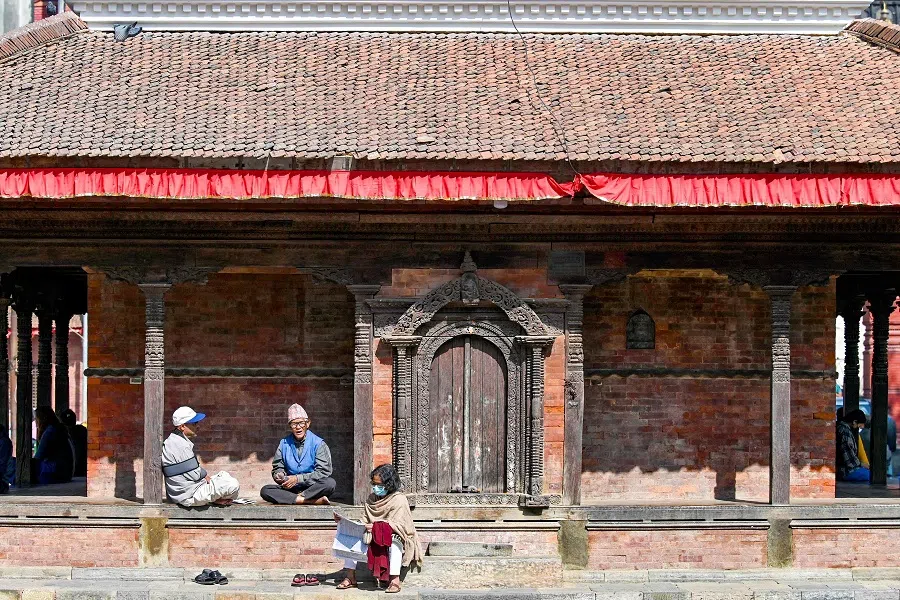 Locals sit at Durbar Square in Kathmandu, Nepal, on 13 November 2024. (Prakash Mathema/AFP)