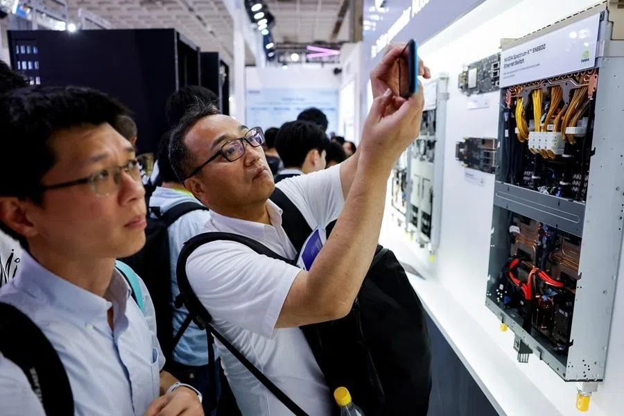 People take photos of an Nvidia Spectrum-X SN6600 Ethernet Switch on display during the annual Computex trade show in Taipei, Taiwan, on 3 June 2026.