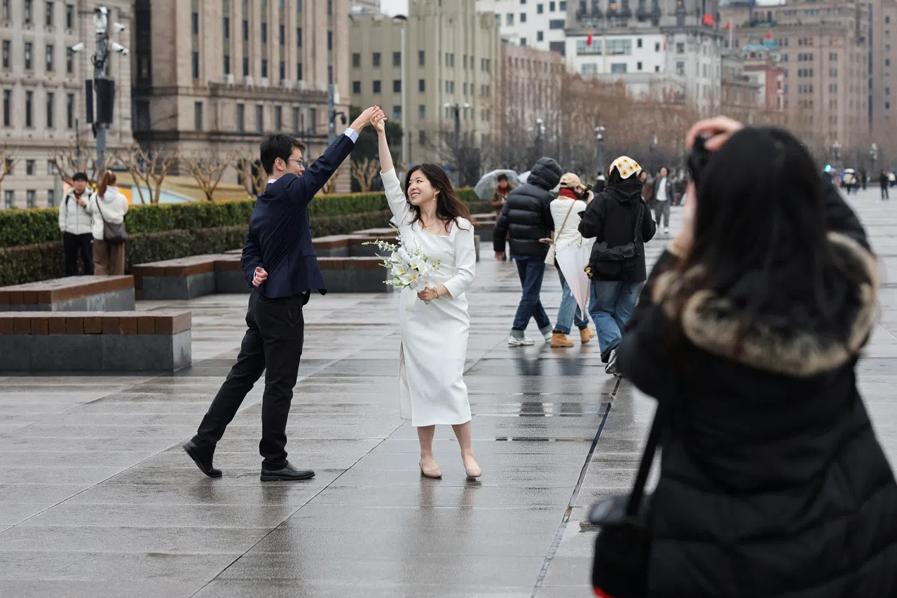 A couple pose during a photoshoot session on the Bund in Shanghai, China, on 14 February 2025.