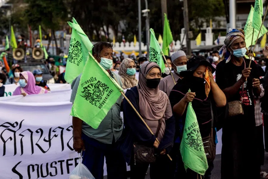 Protesters from Thailand's southern Songkhla province gather outside Government House during a rally demanding authorities halt an industrial park development they say means the expropriation of their land and threatens the environment, in Bangkok on 13 December 2021. (Jack Taylor/AFP)